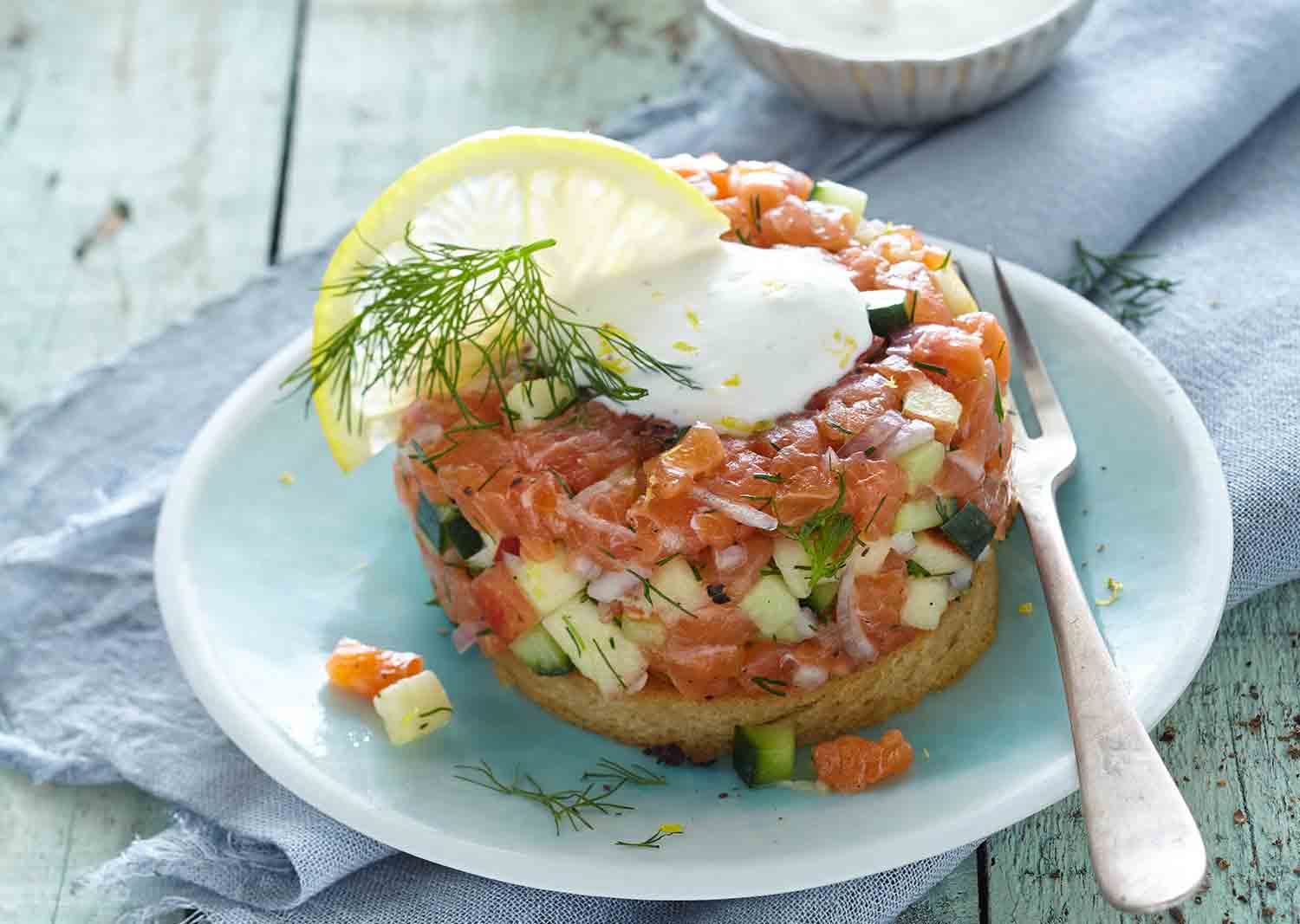 Salmon tartare is an appetiser  with apple, cucumber and dill, on a golden baked crouton.